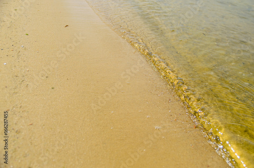 Soft waves on a sandy beach