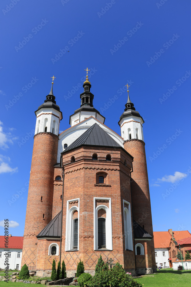 Red brick building of the orthodox church of the Annunciation at the monastic complex with defensive features from 16th and 17th century, Podlasie region, Suprasl, Poland