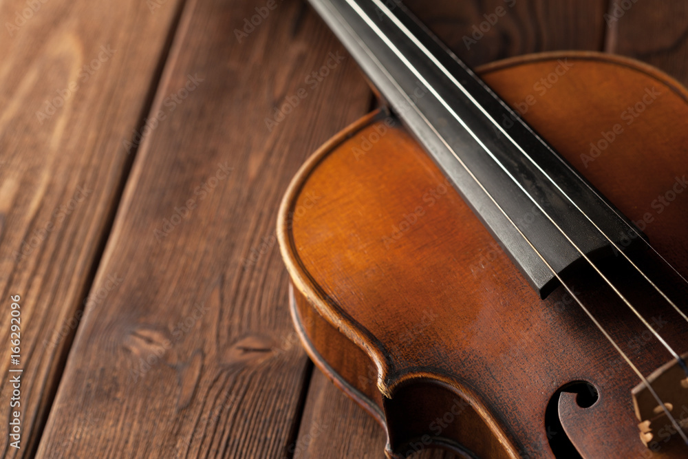Violin on a wooden textured table Violin on a wooden textured table