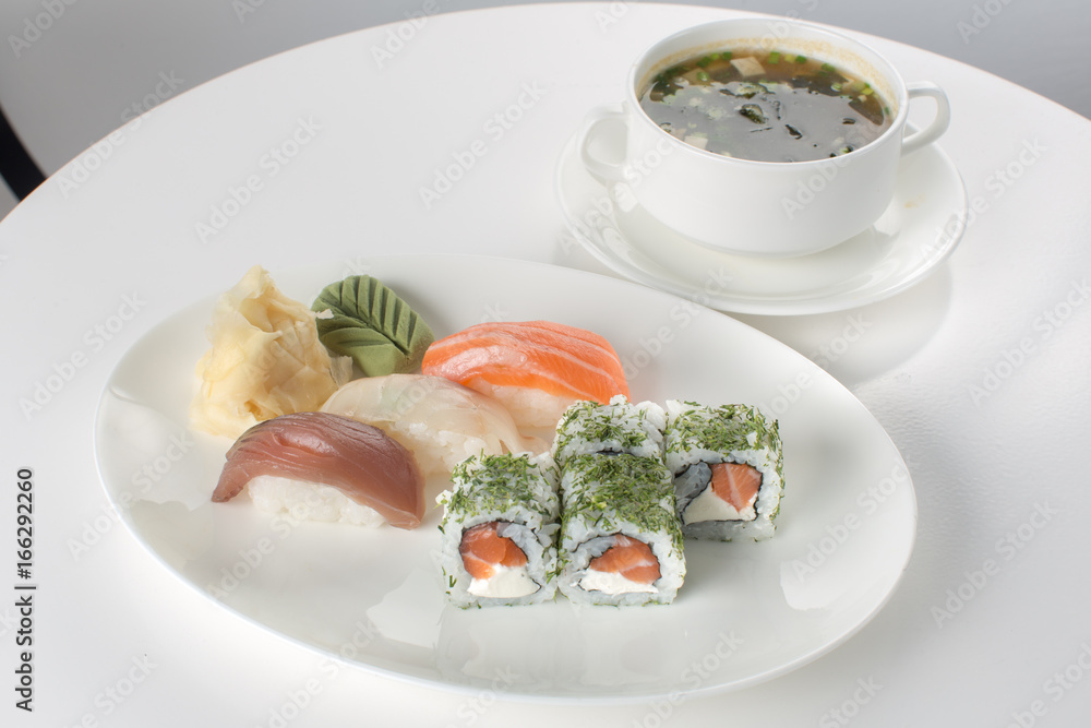 Sushi and soup on white table Sushi and soup on white table