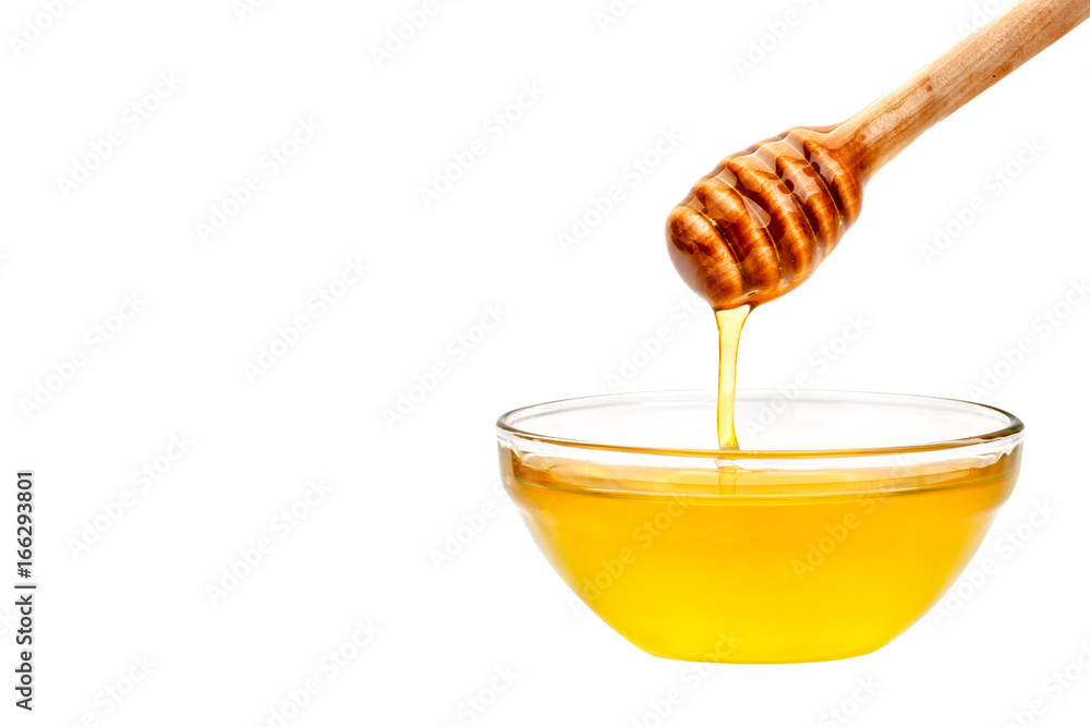 Fresh honey dripping from a spoon. On a white background. Fresh honey dripping from a spoon. On a white background.
