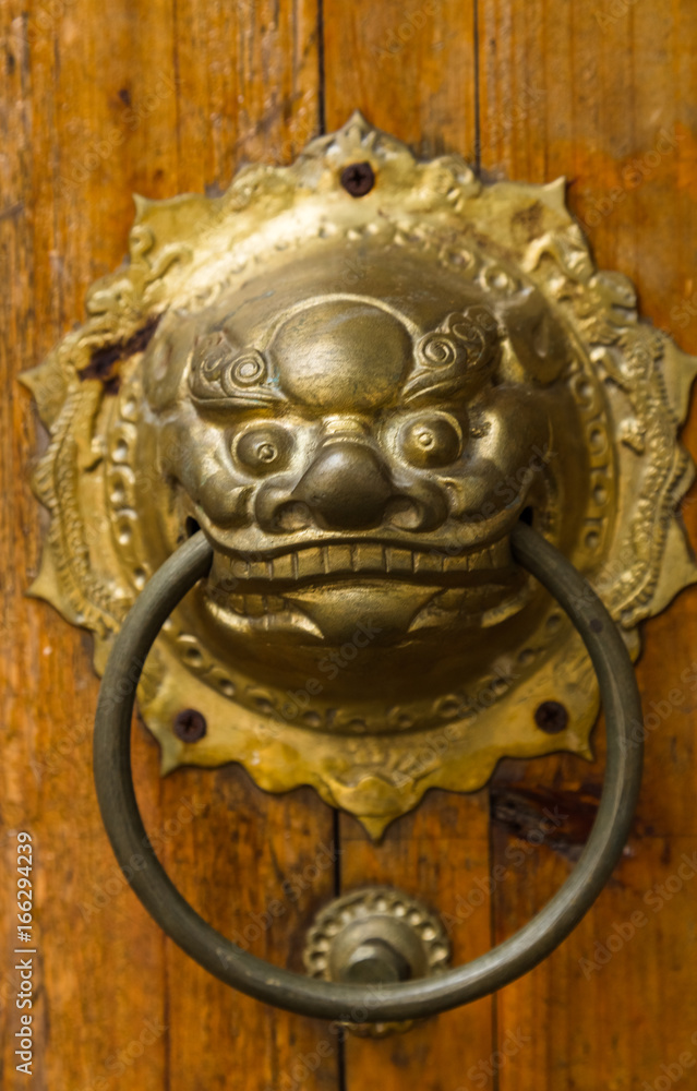 closeup of the antique oriental door knocker,Lishui city,china.