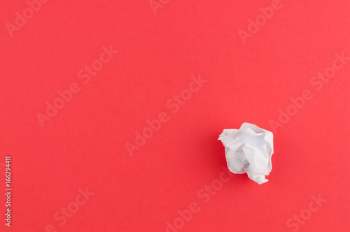 White crumpled paper on red paper background