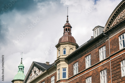 The facade of a historic building against a blue sky in Copenhagen, Denmark. Background and texture