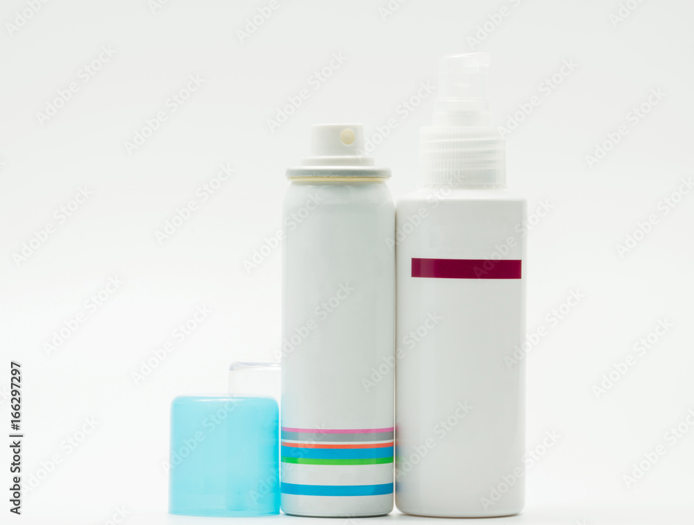 Spray bottle with opened blue cap and pump bottle of skincare on white background, blank label Spray bottle with opened blue cap and pump bottle of skincare on white background, blank label
