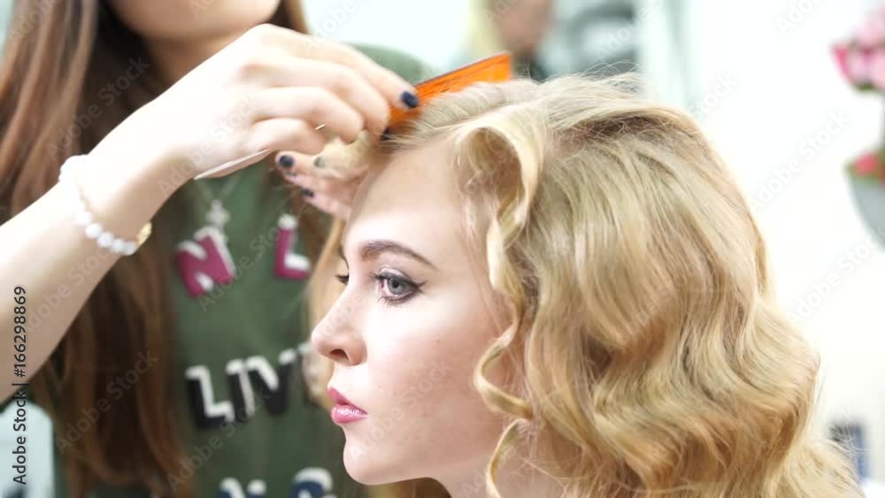 Professional make-up artist prepares a model for a photo shoot Professional make-up artist prepares a model for a photo shoot