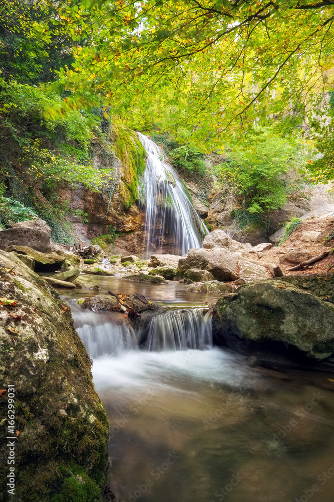 Obraz premium Beautiful autumn landscape with waterfall. Composition of nature