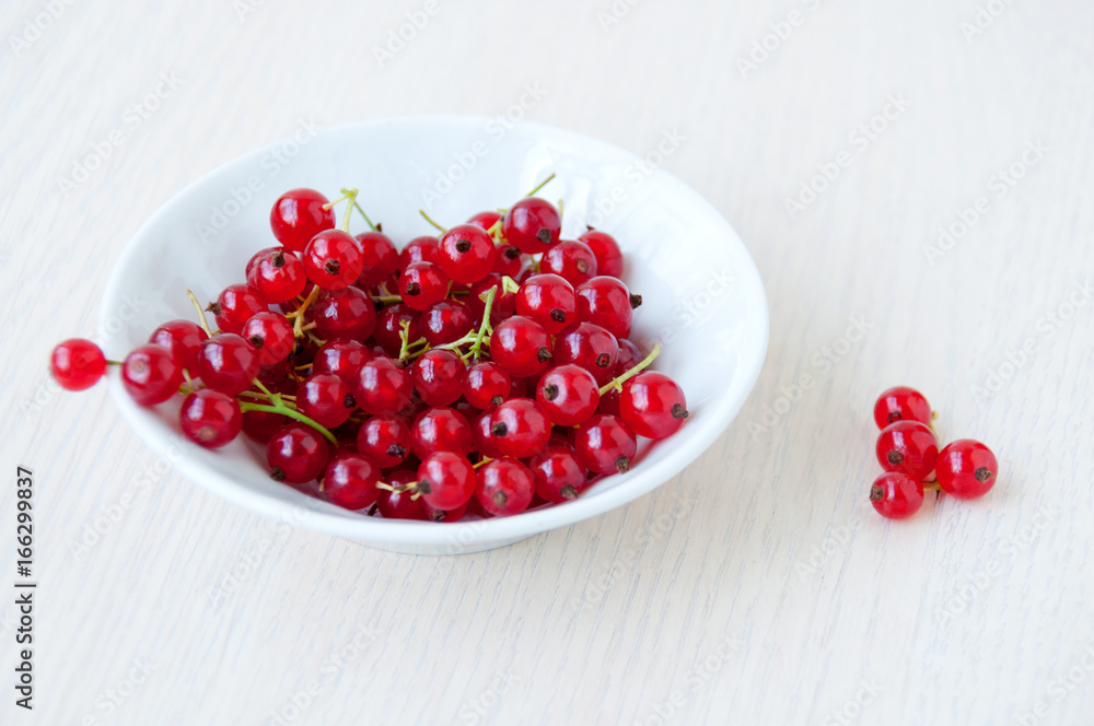 In a white cup red currant berries In a white cup red currant berries