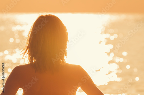 Silhouette of a girl with ocean / sea background.