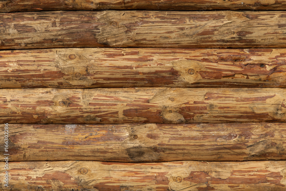 Background of wooden wall texture of crafted logs Background of wooden wall texture of crafted logs