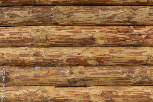 Background of wooden wall texture of crafted logs