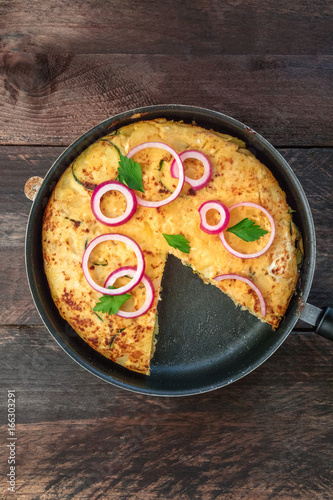 Spanish tortilla in tortillera with copy space, top view