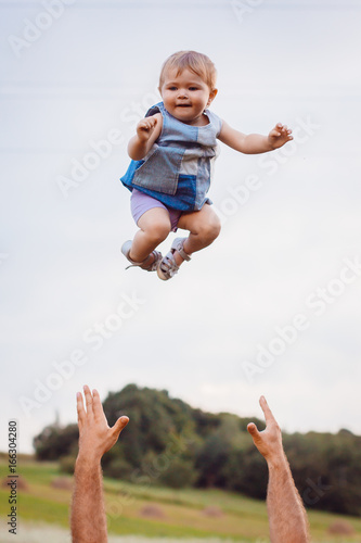 Father throws child up in the air