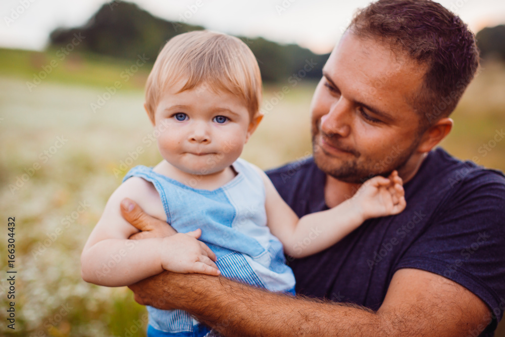 Father holds little boy on his strong arms Father holds little boy on his strong arms