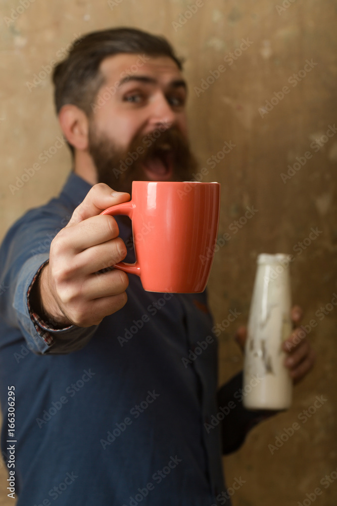 Hipster in shirt with yoghurt and cup. Hipster in shirt with yoghurt and cup.