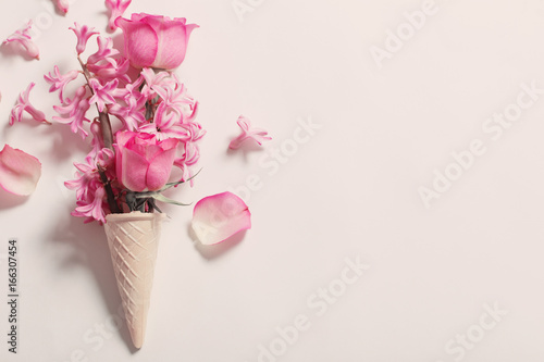 Flowers in a waffle cone on white background