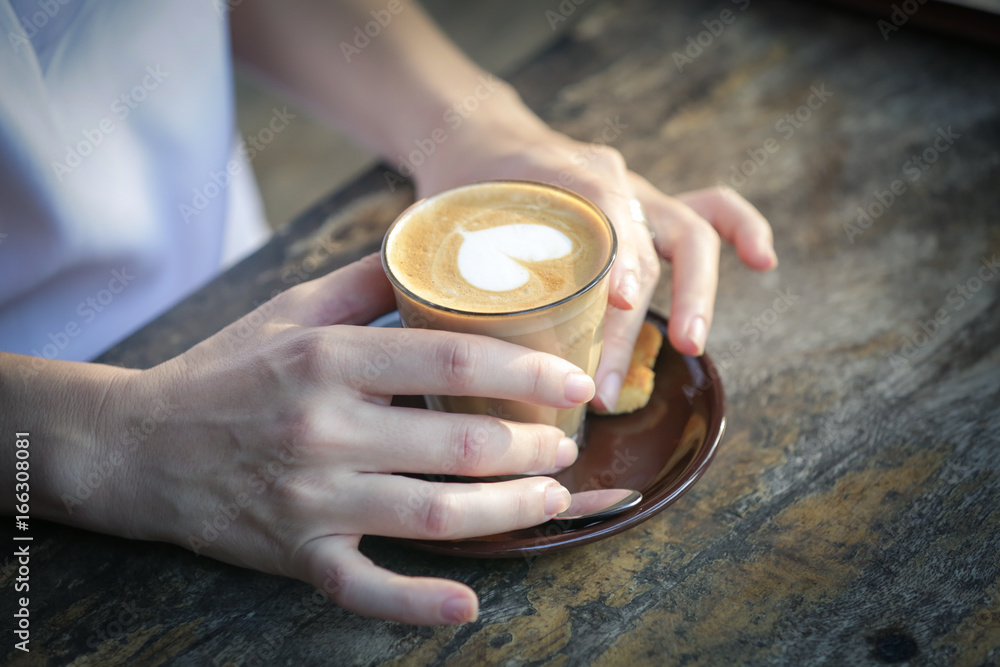 Coffee time. Close up image of girl holding spoon and a cup of coffee Coffee time. Close up image of girl holding spoon and a cup of coffee