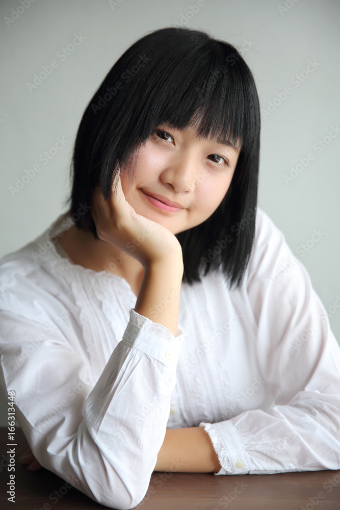 Asian young woman thinking and looking portrait in coffee shop cafe Asian young woman thinking and looking portrait in coffee shop cafe