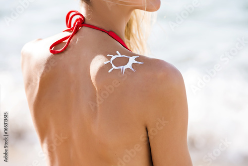 Safety tanning. Woman on the beach