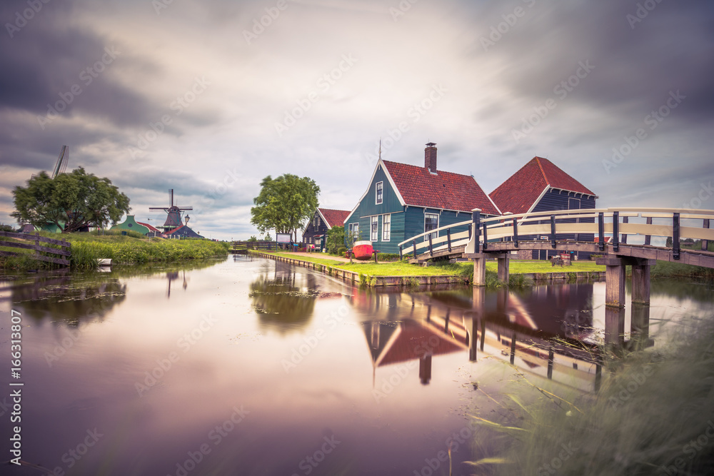 Traditional village with dutch windmills and river at sunset, Holland, Netherlands. Traditional village with dutch windmills and river at sunset, Holland, Netherlands.