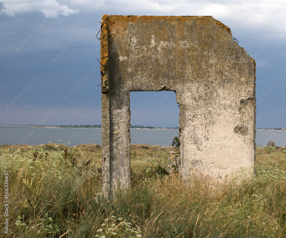 Old concrete doorway of the time of World war two. Island Berezan in Ukraine, Black Sea. Seascape view