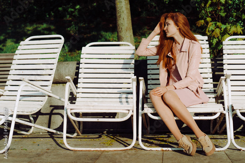 Beautiful red-haired girl in the park