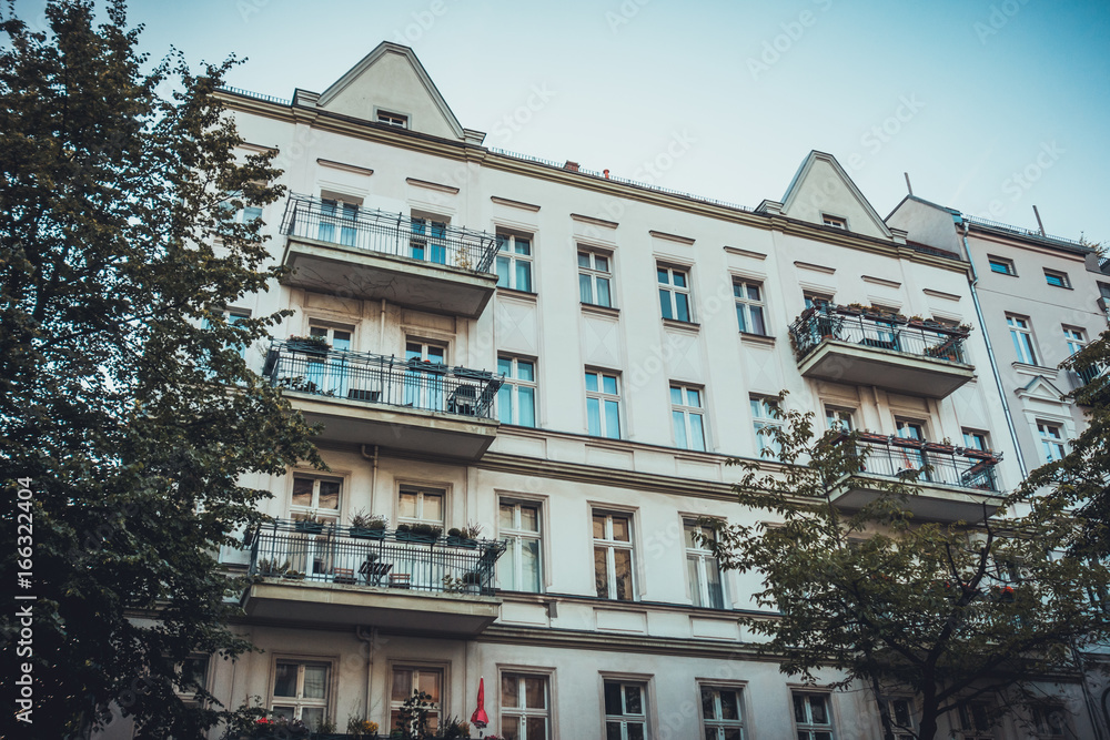 beautiful building with white facade and balconies in a street at berlin