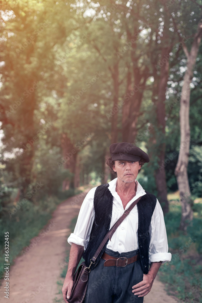 Historical man standing on country road Historical man standing on country road