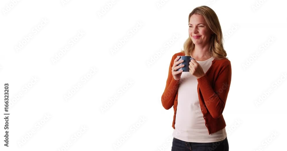 Woman smiling and enjoying warm beverage on white background with copyspace Woman smiling and enjoying warm beverage on white background with copyspace