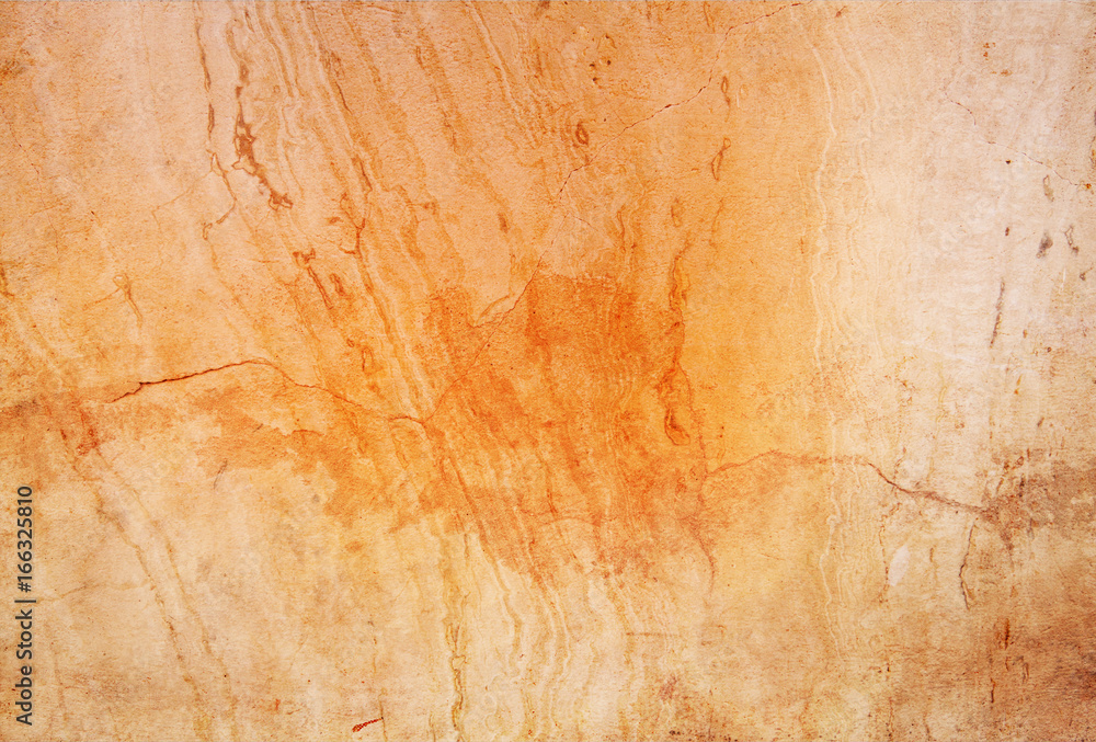 Naklejka premium Brown orange stone texture with cracks natural background