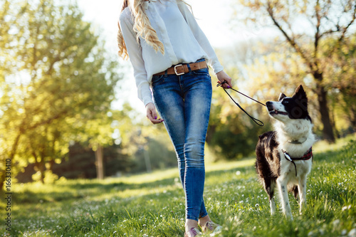 Beautiful woman and dog enjoying their time in nature photo