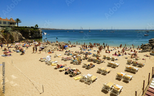CASCAIS, PORTUGAL - 24 JULY 2017: Tourists sunbathing at Conceicao beach in Cascais, Portugal © Helissa