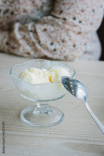 Balls of ice cream in glass bowl