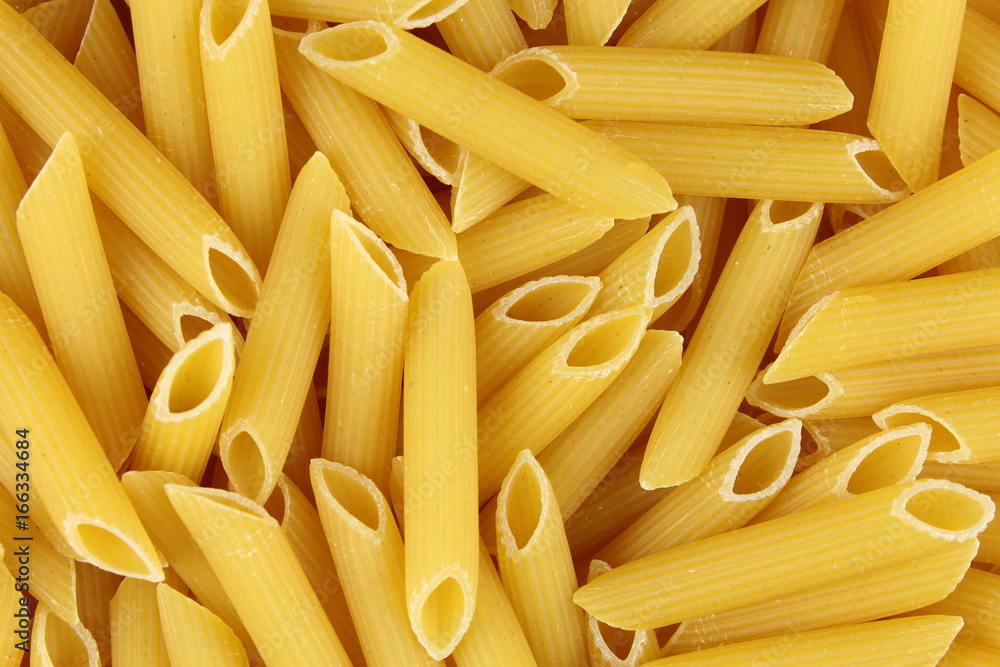 uncooked penne rigate pasta closeup food background texture uncooked penne rigate pasta closeup food background texture