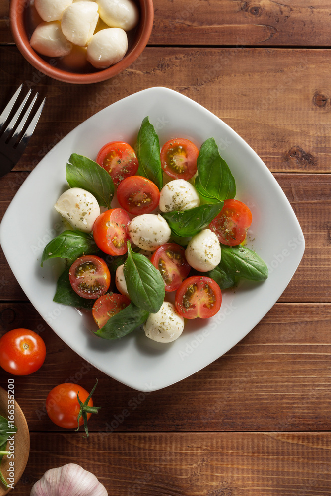 caprese salad in plate at wood caprese salad in plate at wood