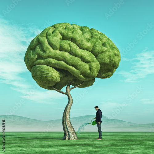 Man squirting a big tree shaped human brain photo