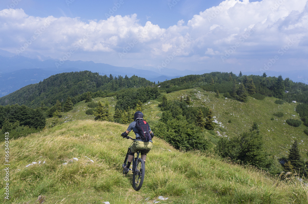 Moutain biker descending from Mozic hill, near Soriska planina. Moutain biker descending from Mozic hill, near Soriska planina.