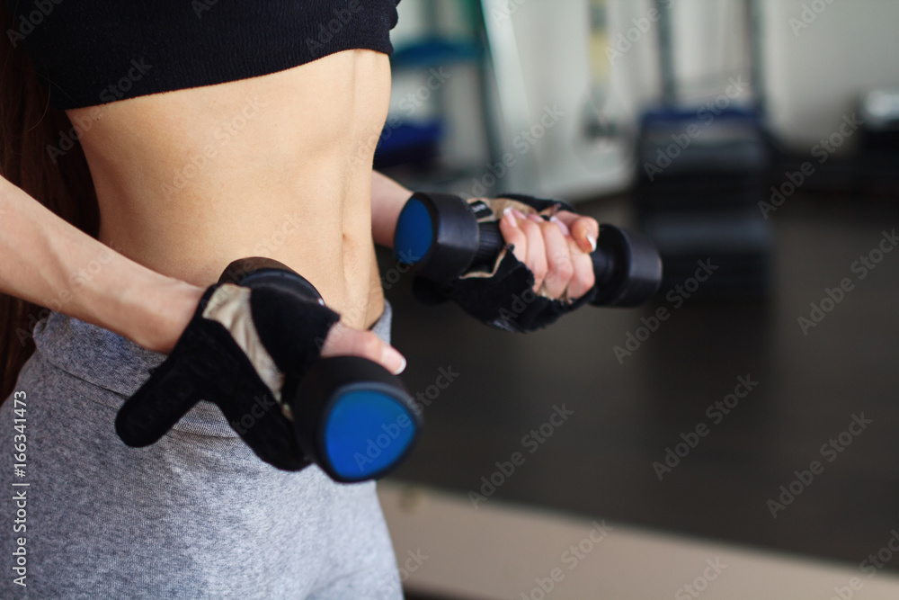 Close up of girl's hands with dumbbells Close up of girl's hands with dumbbells