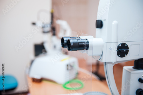 Fragment of ophthalmic laser system in eye surgery clinic. Selective focus, close up.