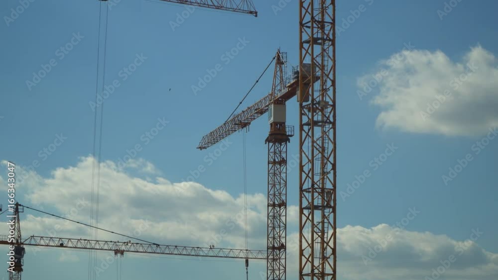 Cranes working on construction of the housing estate in former industrial zone.