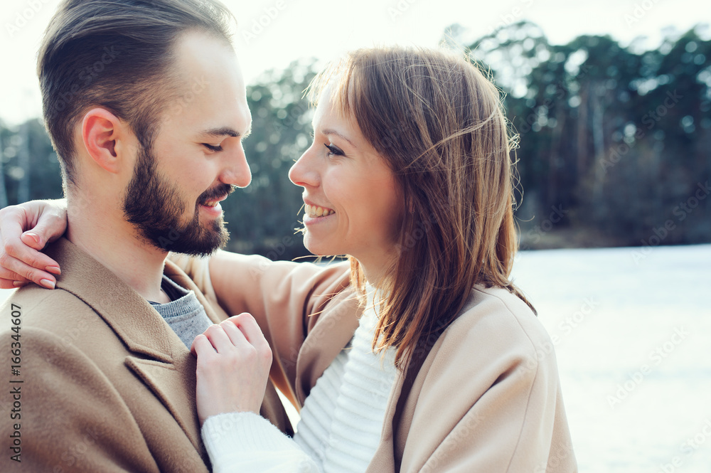 young happy loving couple walking outdoor in autumn or early spring young happy loving couple walking outdoor in autumn or early spring