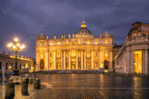 Sunrise over the St. Peters Basilica in Vatican City. Morning at the most famous landmark, empty of people street, cloudy sky.