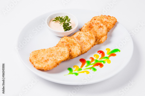 Chicken cutlet on a round white plate