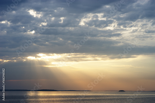 Sunset rays over the ocean landscape background © spacedrone808