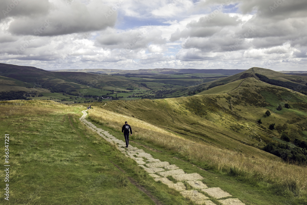 Man walking in the Derbyshire Countryside in the UK Man walking in the Derbyshire Countryside in the UK