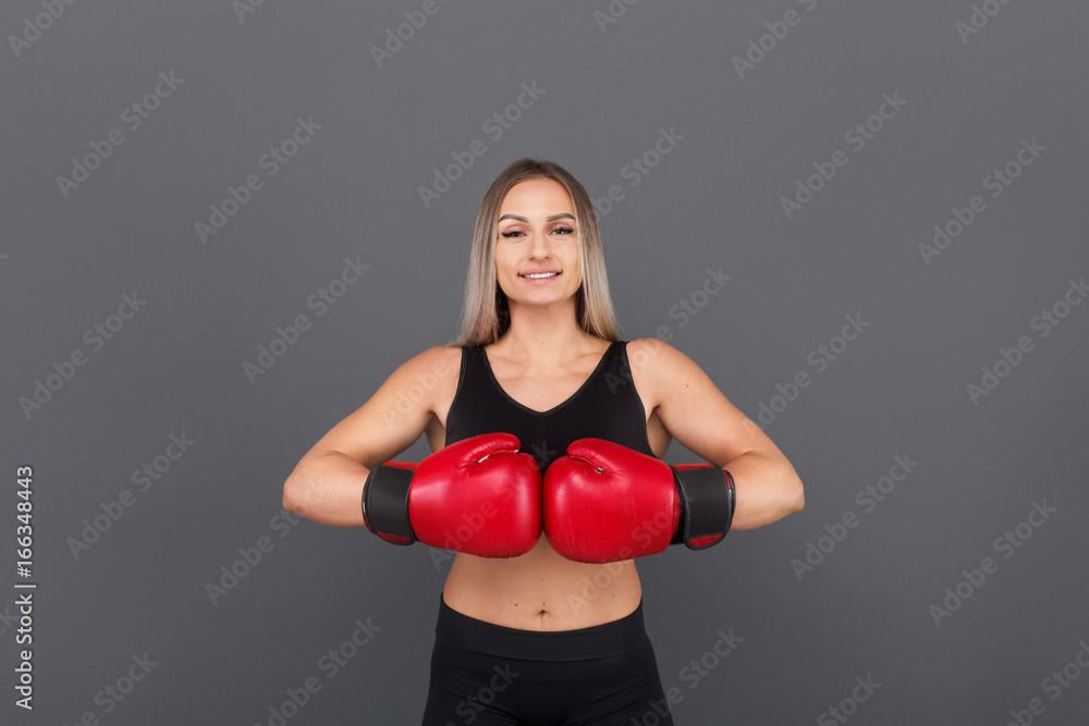 Blonde woman posing wearing boxing gloves Blonde woman posing wearing boxing gloves