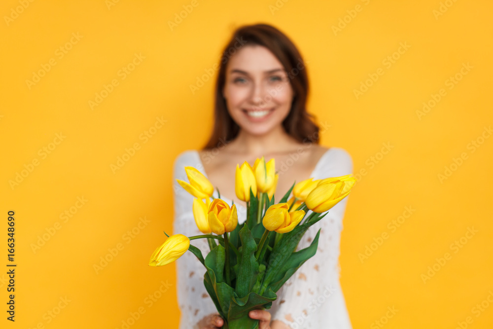 Smiling woman posing with tulips Smiling woman posing with tulips