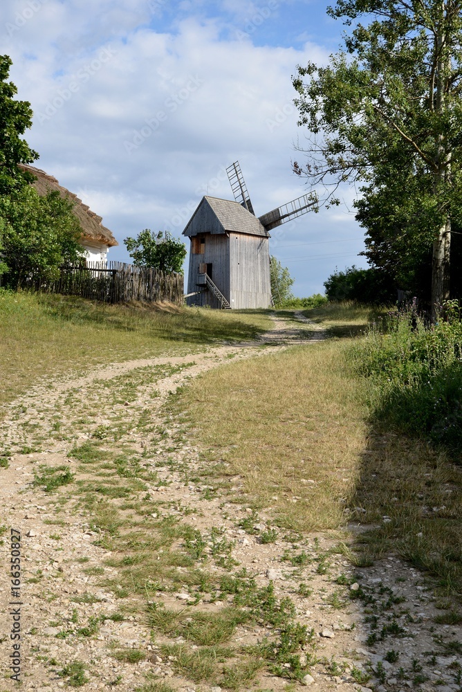 Old grain mill and stony country road