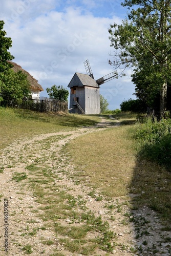 Obraz na płótnie Old grain mill and stony country road w salonie