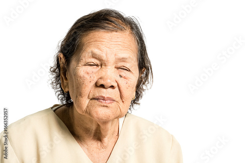 Portrait of a mature woman แlose her's eyes. Isolated on white background with clipping path